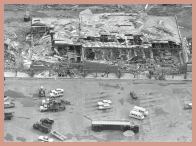 An aerial view of a tornado-damaged shopping plaza.