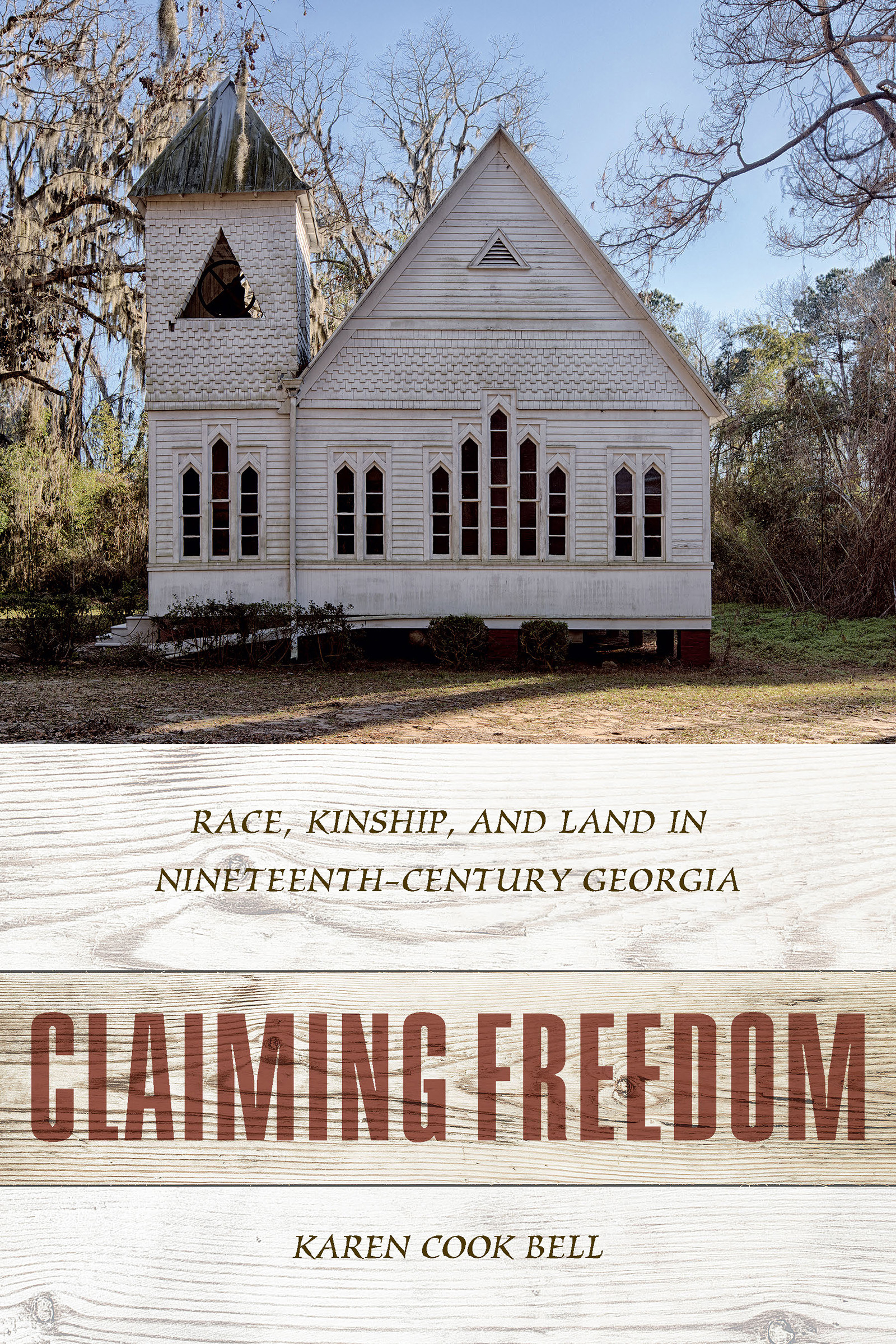 Inset photograph of an old, white church in a wooded area. Below, pale tan background with wooden texture. Red title, brown author name and subtitle.